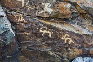 Hunting scenes prehistorical petroglyphs photo