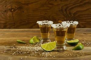 Two gold tequila shots, copy space photo