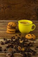 Coffee cup and chocolate cookie, vertical photo