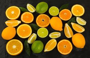 Lime, lemon, orange and tangerine on black background