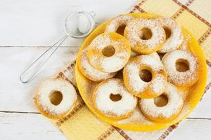 Homemade donuts on yellow plate photo