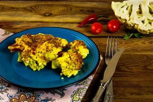 Baked cauliflower blue plate photo