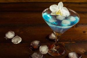 Cocktail Blue Martini on the dark wooden background photo