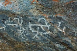 Palaeolithic Petroglyphs carved in rocks photo