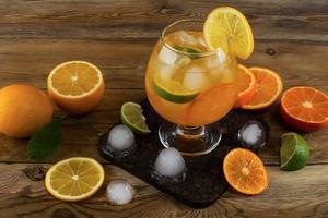 Fresh citrus drink on wooden background photo