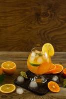 Cool fruit cocktail on wooden table, place for text photo