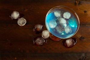 Blue Curacao liqueur with ice, top view photo