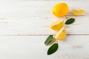 Juicy lemons and lemon slices photo