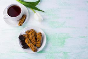 Chocolate biscuits and tea cup photo