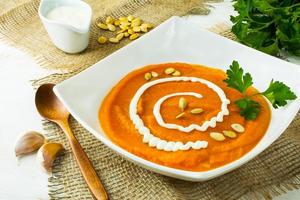 Pumpkin soup with cream and pumpkin seeds photo