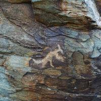 Prehistorical petroglyphs carved in stones photo
