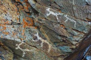 Mesolithic Petroglyphs carved in rocks photo