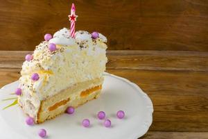 Slice of peach and meringue birthday cake photo