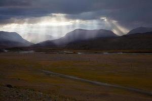 Rays of sunlight passing through the rain clouds photo