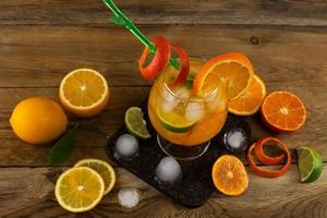 Fresh citrus drink on wooden table photo