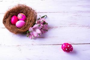 pink Easter eggs in a nest photo