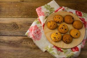 Homemade chocolate biscuits on a round wooden board photo