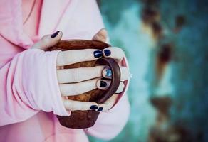 Cup of tea in girl's hands photo