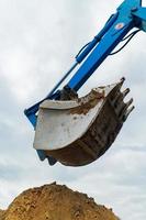 blue bucket excavator close up photo