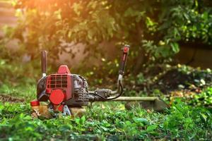 lawn mower lying on the grass photo