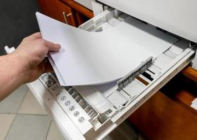 paper in printer. sets the paper stack in the laser printer. photo