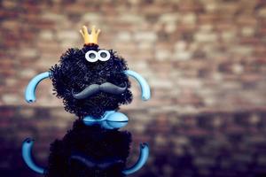 a coronavirus toy figure with a crown on its head. photo