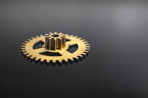 brass gear from the clock black background macro photo