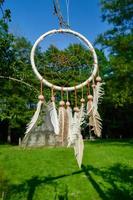 dreamcatcher on the background of an Indian village of wigwams photo