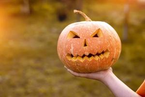 scary Halloween pumpkin in hand photo