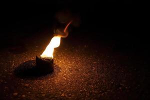 fire burns in a bowl on the ground photo