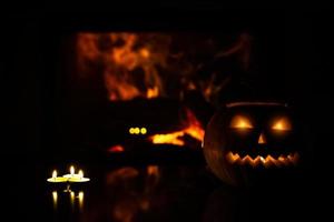 three candles on a blurry background of flames and pumpkins to celebrate Halloween. photo