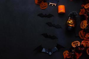 Dark halloween flat lay background concept with lantern and accessories photo