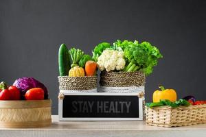 Various of fresh colorful vegetables with letterboard says stay healthy on wooden table photo