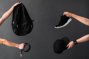 cosecha de mano que ofrece ropa y accesorios negros para el concepto de promoción de venta de viernes negro y adicto a las compras
