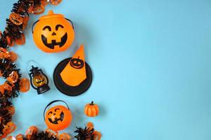 Creative flat lay of various Halloween decoration on blue background with copy space photo
