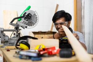 Carpenter worker looking and choosing wood in the workshop photo