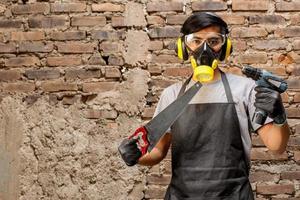 Carpenter man holding saws and drills photo