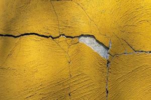 cracked yellow plaster wall texture background