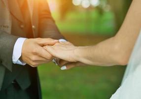 close UPS of the hands of the newlyweds photo