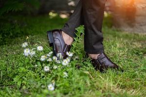 men's feet in brown shoes close up photo