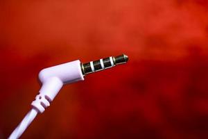 headset plug close-up on a red background macro photo. photo