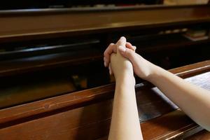 woman praying in the temple. Hand closeup photo