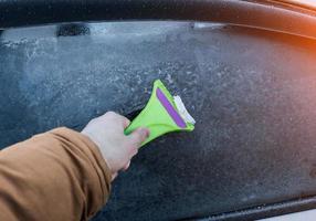 cleaning the car glass from ice photo