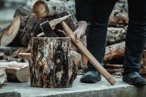 broken axe when chopping wood. The woodcutter broke the tool. photo