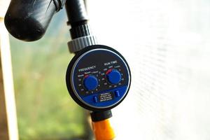 drip irrigation timer in the greenhouse close-up photo