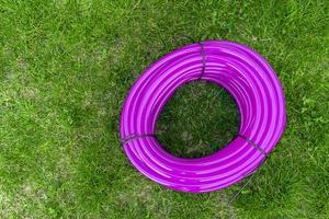 coiled silicone watering hose on the lawn photo