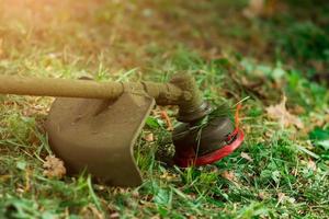 lawn mower lying on the grass photo