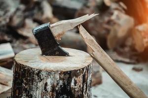 A broken axe in the wooden deck photo