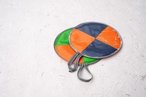 multi-colored sledges for skating downhill lie on the snow. photo