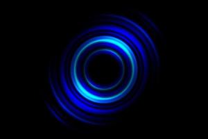 Abstract glowing circle blue light effect on black background photo